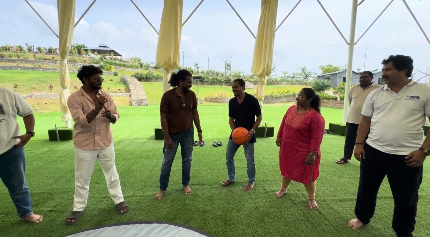 Colleagues playing an outdoor game with a basketball