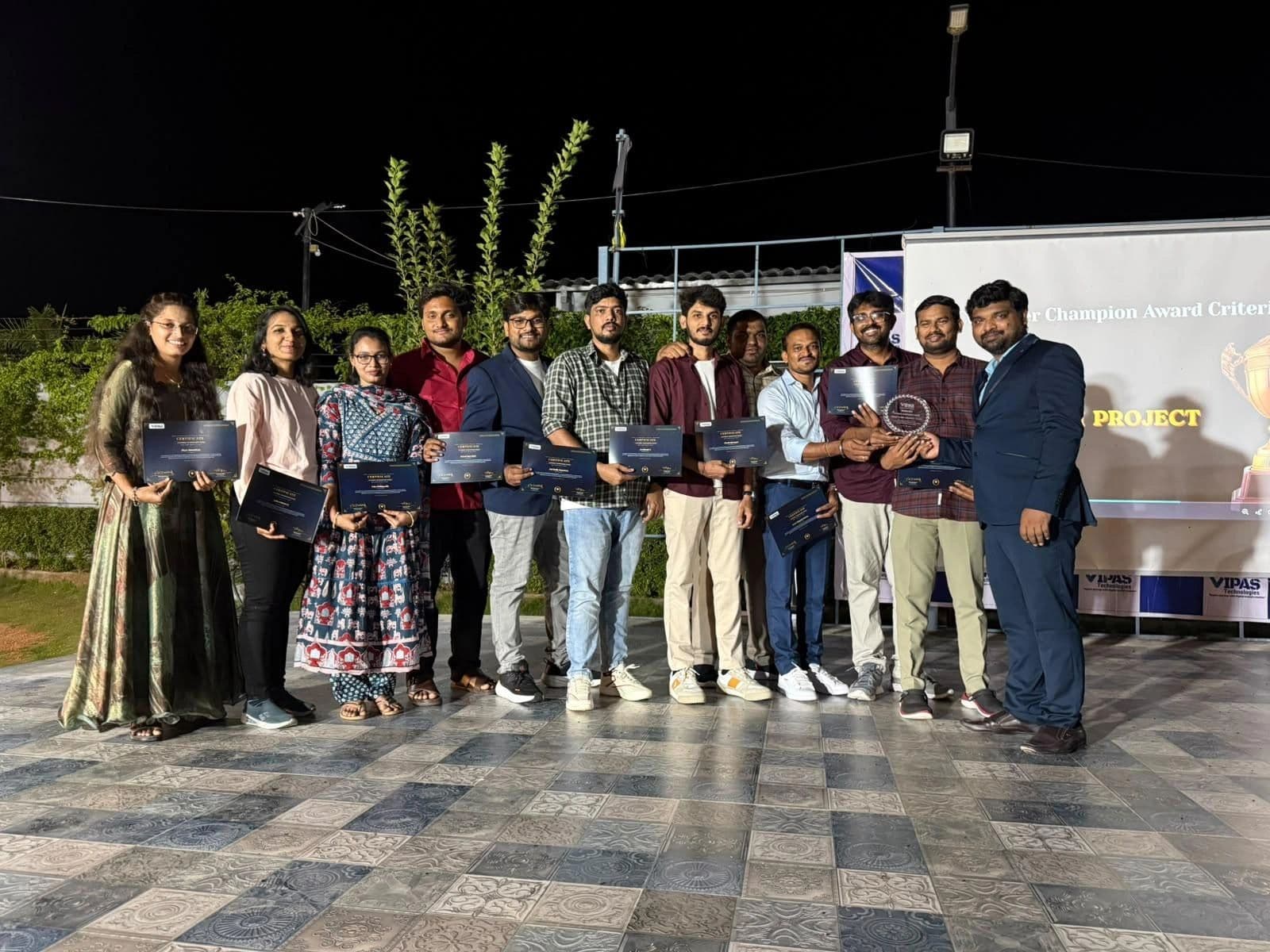 The team on stage receiving certificates and a trophy