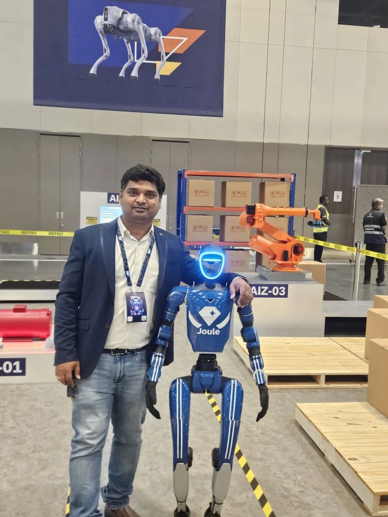 A Vipas team member with SAP's Joule robot at an industry expo