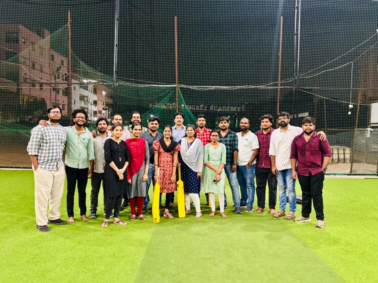 The Vipas team at a cricket ground, bats in hand